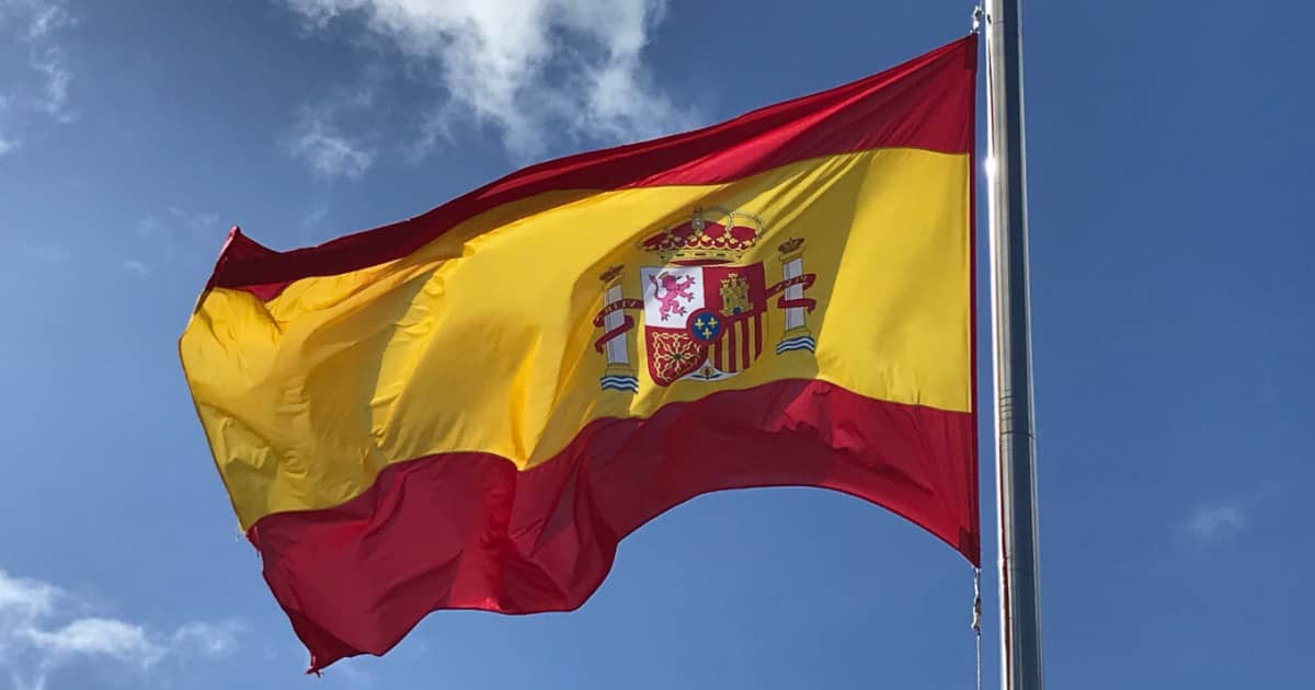 Spanish national flag flying on a sunny day.