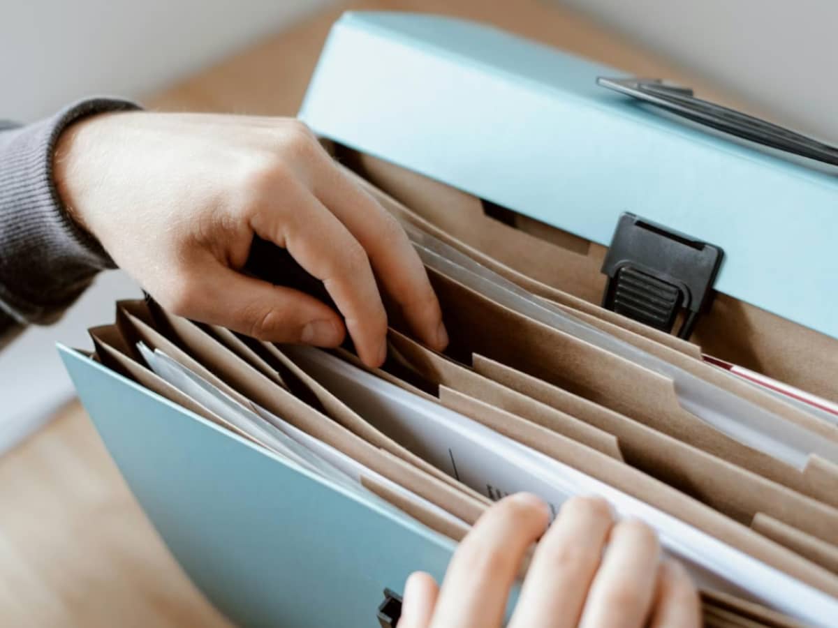 Hands shuffling through folders and files (stock image)