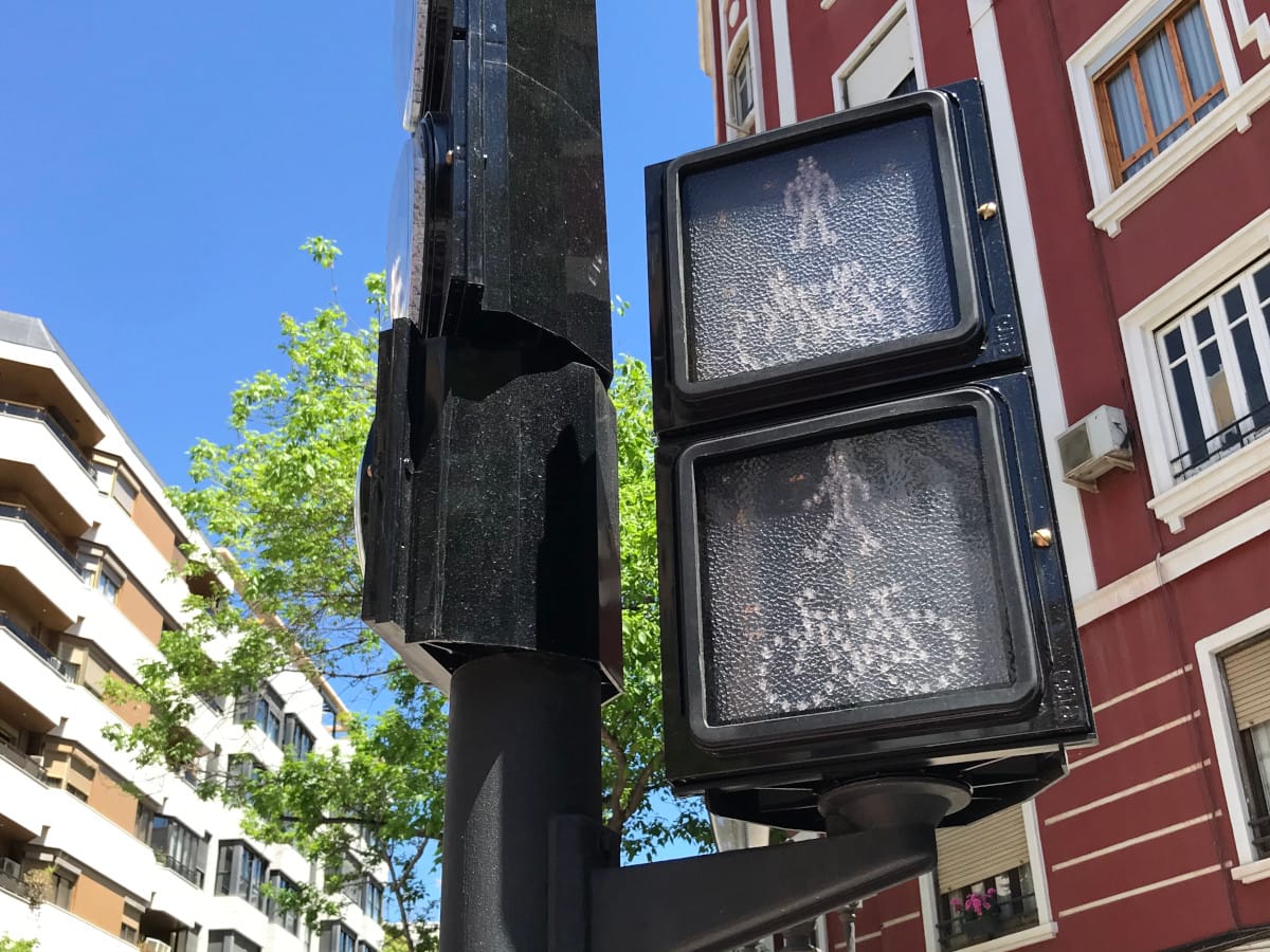 A stop light and pedestrian crossing light on a pole without power