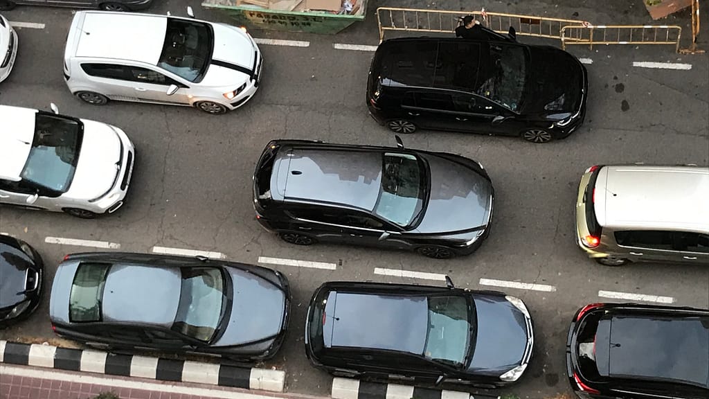 Cars in bumper-to-bumper traffic seen from above.