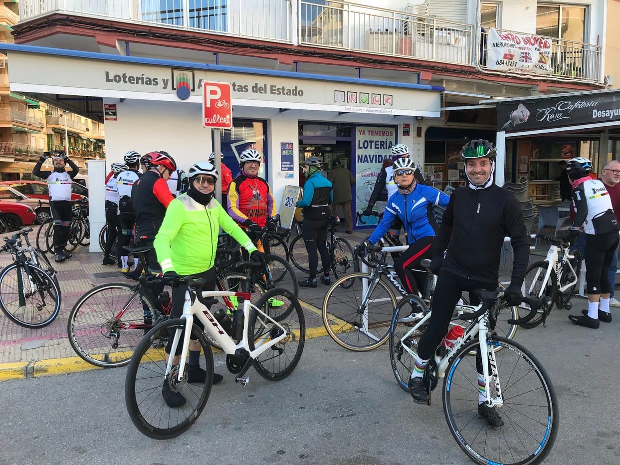 Bicyclists and bicycles outside of a Loterías y Apuestas del Estado in Cullera, Spain
