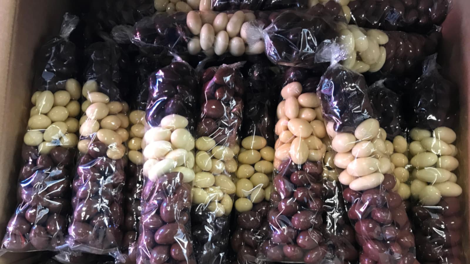 Turrones or candies being packed in cardboard boxes for shipping.