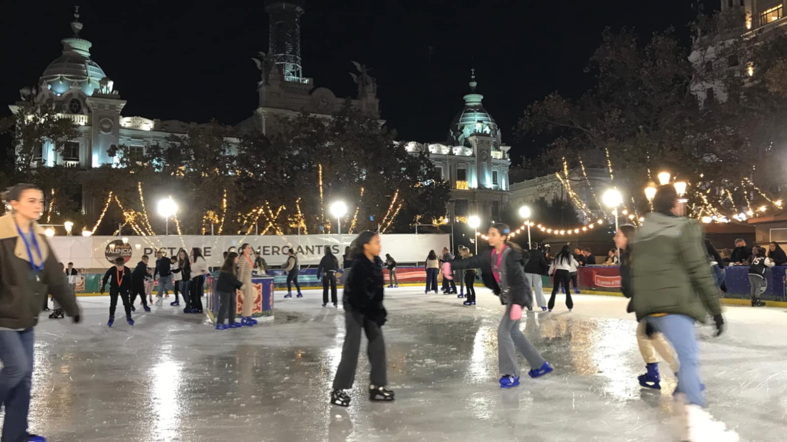 Ice skaters circling an Ice rink in Valencia, Spain.