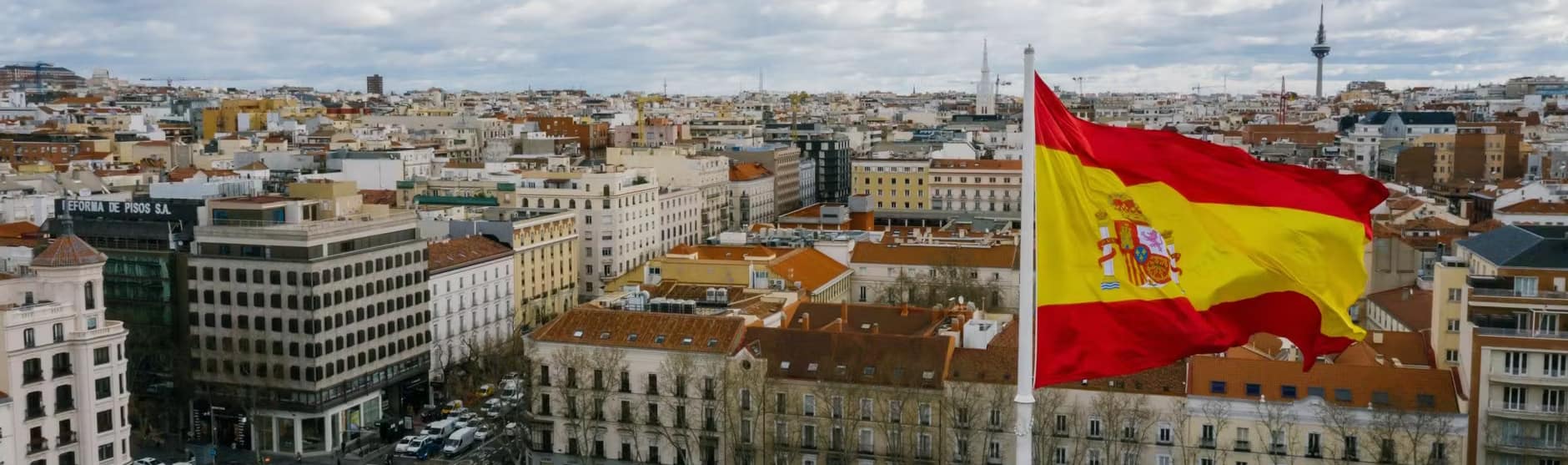 spanish national flag against cityscape