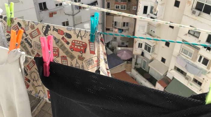 Clothes pins and clothes hanging outside to dry.