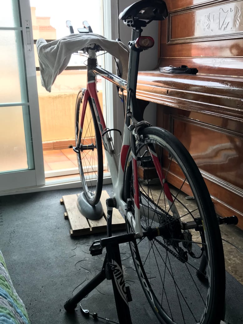Time trial bike attached to trainer with door open to outside view.
