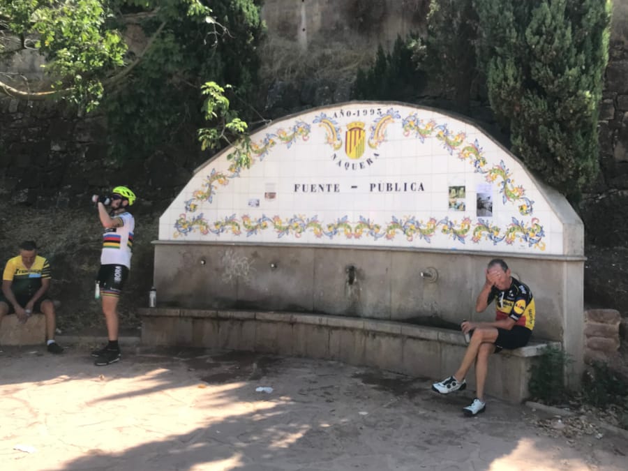 A semi-curved, tile marker runs along the length of a water fountain.