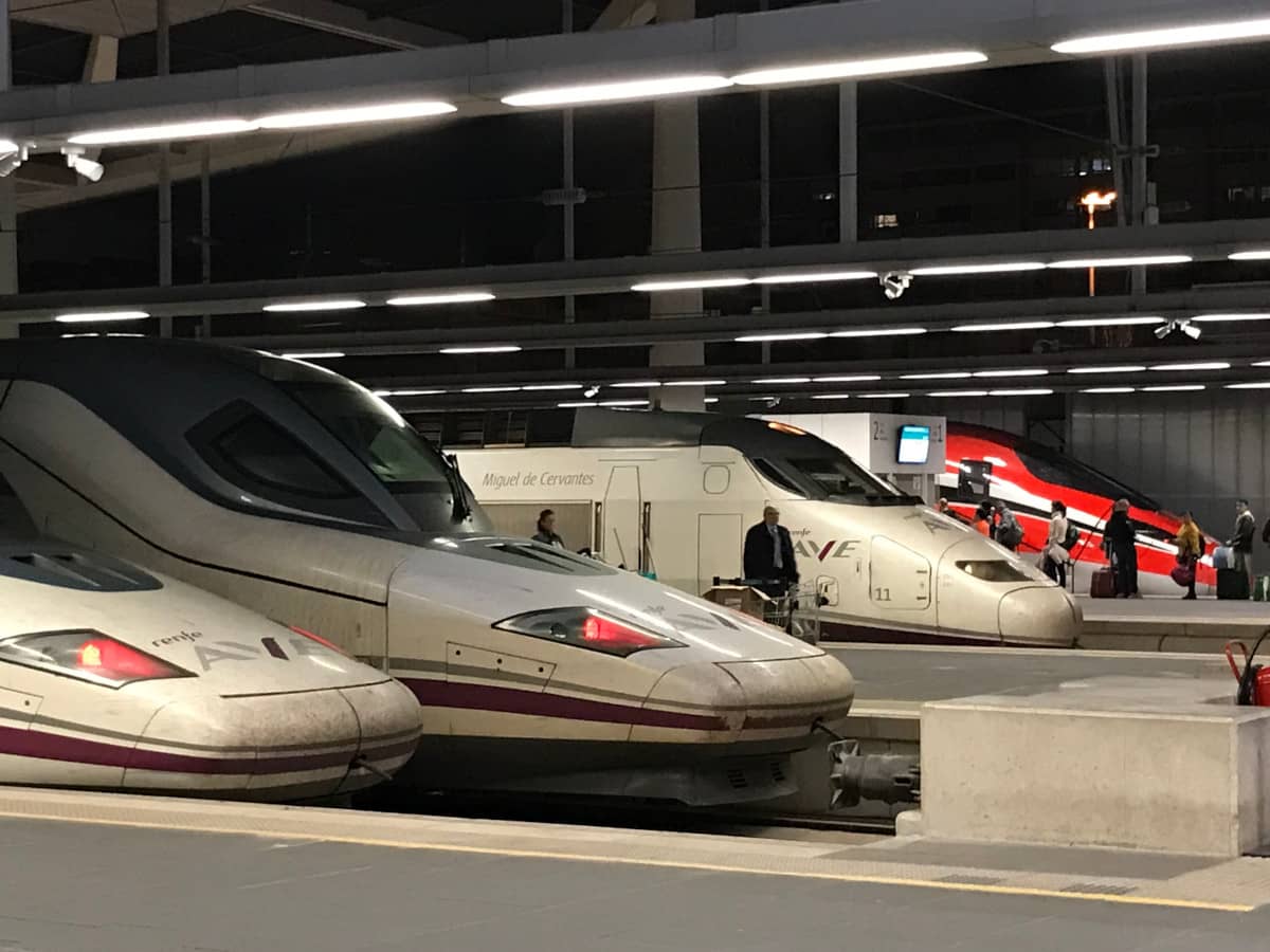 Several high-speed train engines are lined up at a train station.