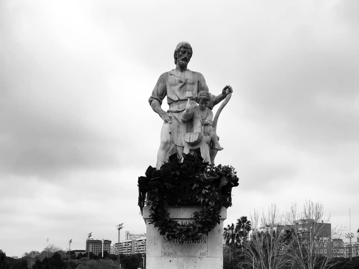 Statue of St. Joseph against a cloudy sky.